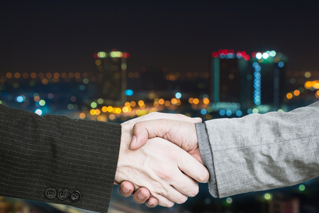 Teamwork begins with business agreement with blurred city background.の写真素材