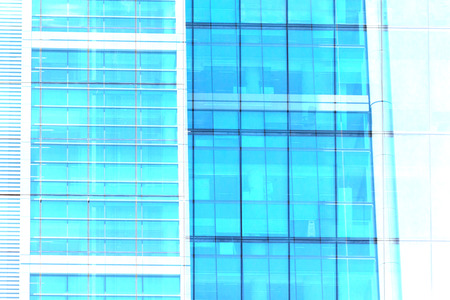 Building facade with modern window design for steel glass office tower.  Copy space and fade.の写真素材