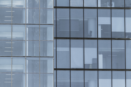 Building facade with modern window design for steel glass office tower.  Copy space and fade.