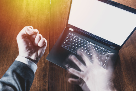 Business laptop with hands in anger.  Professional worker disappointed and shocked with empty copy space on white screen.の写真素材