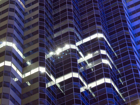 Privacy of individual apartment units with lit windows at night.の写真素材