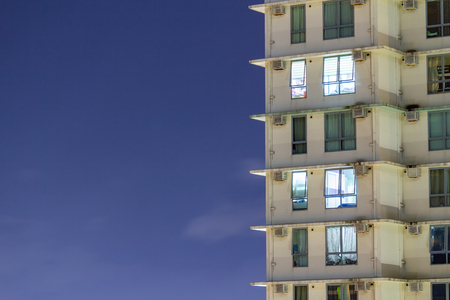 City apartment windows at night.  Residential highrise residences for metro housing in urban environment.の写真素材