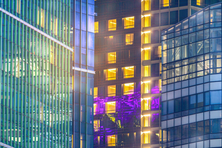 Central city property for rent and lease with apartment windows at night.  Real estate agent selling condos for housing in beautiful contemporary buildings.の写真素材
