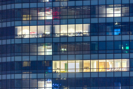 Central city property for rent and lease with apartment windows at night.  Real estate agent selling condos for housing in beautiful contemporary buildings.の写真素材