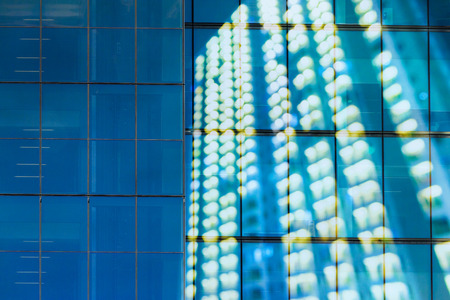 Bokeh apartment windows at night for blurry modern highrise city scene.の写真素材