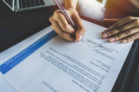 Financial business contract.  Reading paperwork details and signing business contract.の写真素材