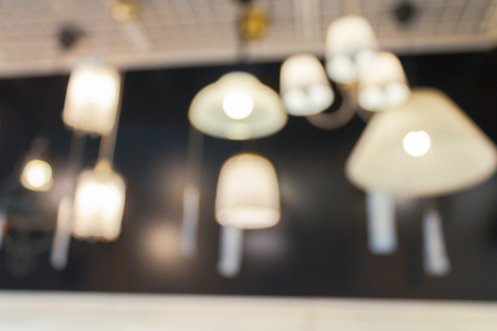 Light fixtures and bulbs in blurred shot at home department store.  Abstract hangings on wall.の写真素材