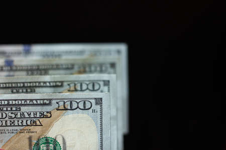Hundred dollar bills isolated and aligned with blur.  Business and financial abundance and USD...