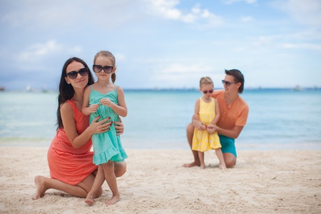 Young beautiful family with two kids on tropical vacationの写真素材