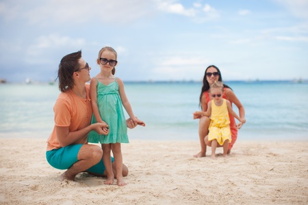 Young beautiful family with two kids on tropical vacationの写真素材