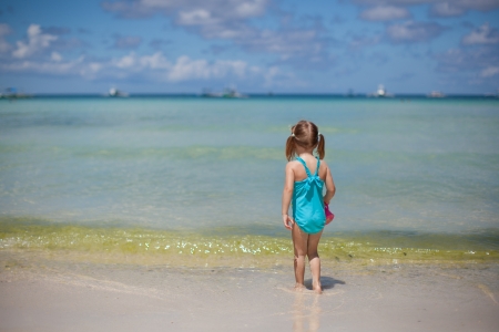Adorable little girl on tropical beach vacationの写真素材