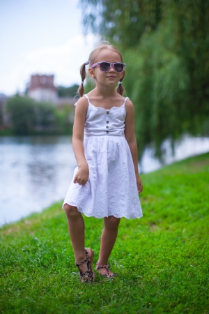 Beautiful happy girl walking outdoor near the lakeの写真素材