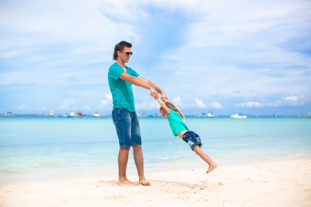 Young father and his little daughter on exotic white sand beachの写真素材