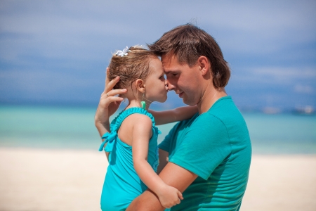 Portrait of a little girl kissing a dad in the noseの写真素材