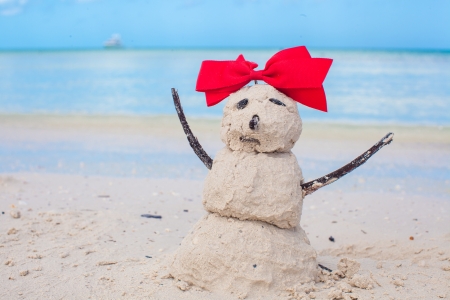 Little sandy snowman with bow on a sandy Caribbean beachの写真素材