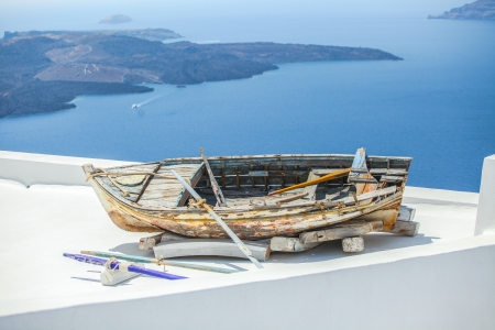 Famous old boat on the roof of house in Santorini island in Greeceの写真素材