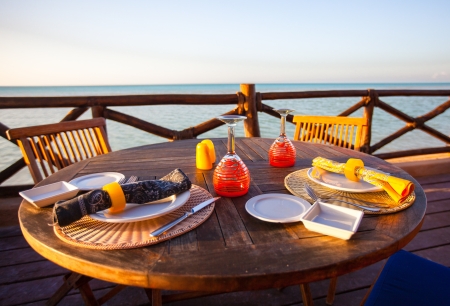 served open air table on the porch at sunsetの写真素材