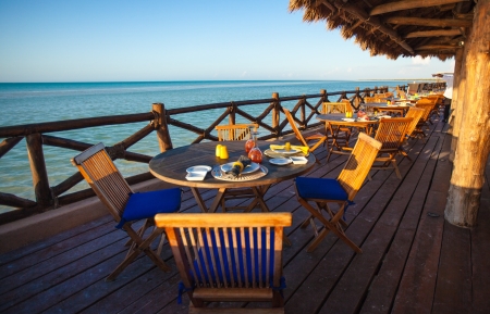 Summer empty open air restaraunt near sea at sunsetの写真素材