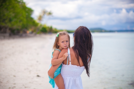 Young mother and her little daughter enjoying beach vacationの写真素材