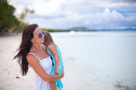 Young mother and her little daughter enjoying beach vacationの写真素材