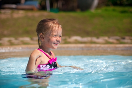 Profile of a little girl enjoy in the swimming poolの写真素材