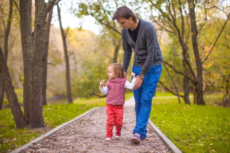 Young happy father with daughter in the park have funの写真素材