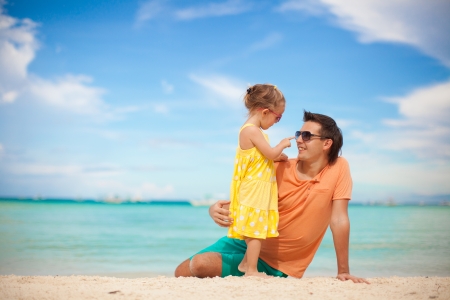 Happy father and his adorable little daughter at beachの写真素材
