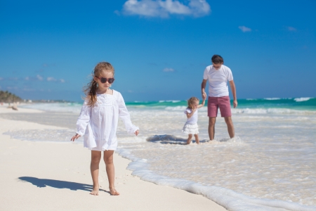 Young dad and his cute daughters enjoy summer vacationの写真素材