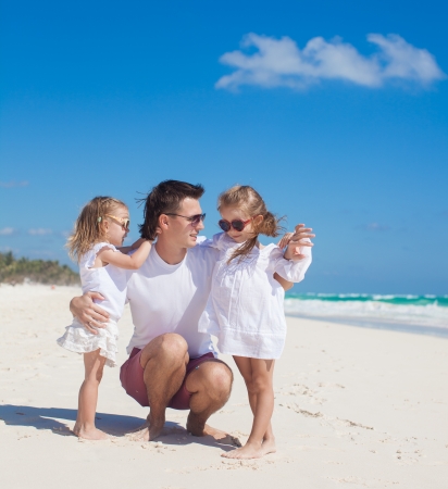 Happy father and his adorable little daughters on sunny dayの写真素材