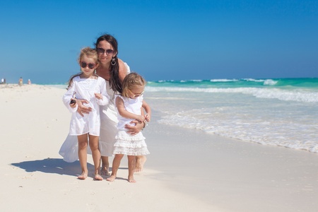 Young mother and her little daughters enjoy summer vacationの写真素材