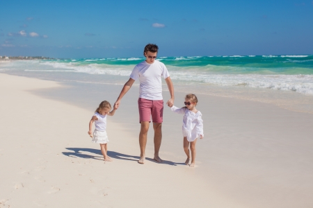 Happy father and his adorable little daughters on sunny dayの写真素材