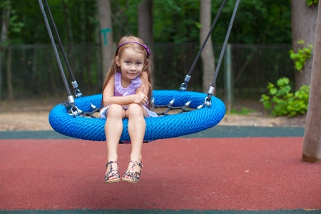 Little girl on a swing at an amusement parkの写真素材