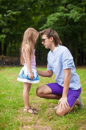 Young happy father with cute daughter in the park have funの写真素材