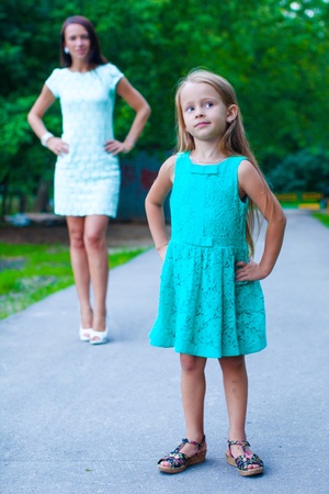 Close-up of little fashion girl on background of young motherの写真素材