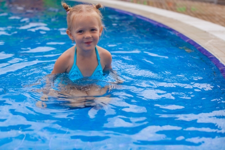 Adorable little girl enjoy in the swimming poolの写真素材