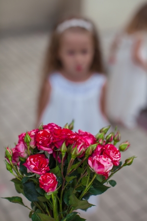 Charming bouquet of red roses in woman's hand background the girkの写真素材