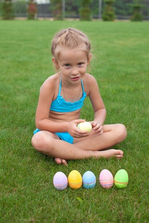Little beautiful girl holding an Easter eggの写真素材