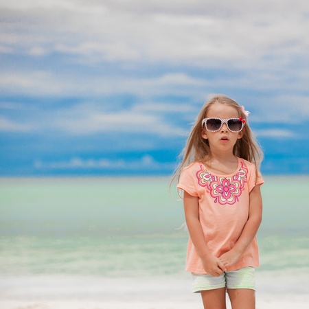 Adorable little girl on tropical beach vacationの写真素材
