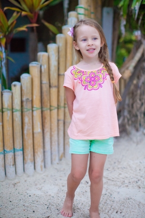 Adorable little girl smiling on tropical beach vacationの写真素材