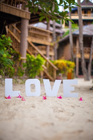 Word "love" on the sandy beach at beautiful resortの写真素材