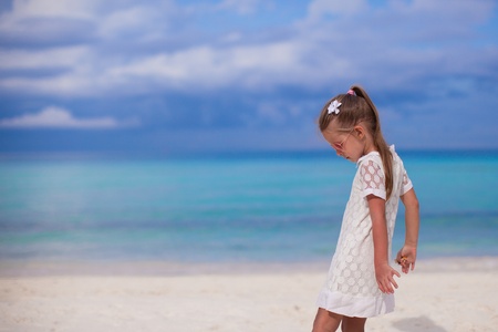 Cute little girl walking on tropical beach vacationの写真素材