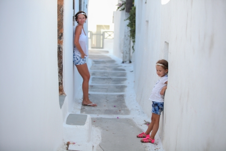 Young mother with her little daughter in a Greek village on the Cyclades Islandsの写真素材