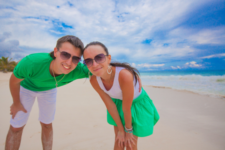 Happy young couple have fun on exotic beach looking at cameraの写真素材
