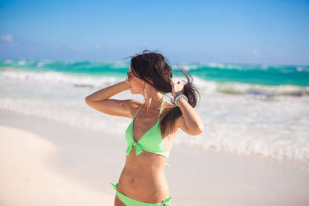 Portrait of Young woman enjoying the holiday on a white, tropical beach at sunny dayの写真素材
