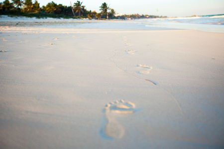 Human footprints on the white sandy beachの写真素材