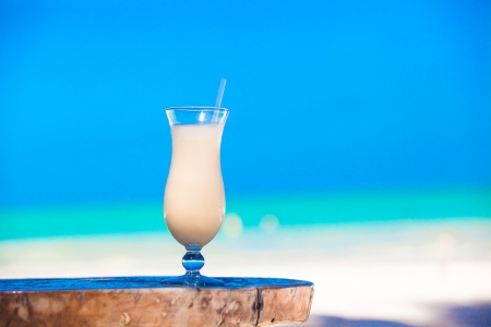 White pina colada on the table on the beach