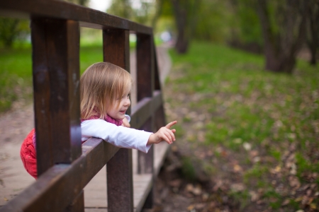 Little girl walking outdoor, having fun and laughtingの写真素材