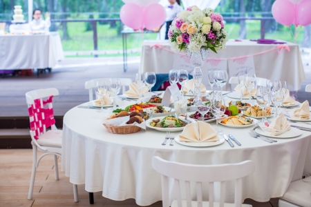 Wedding white banquet tables prepared for wedding celebrationの写真素材