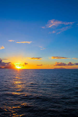 Amazing colorful sunset on an exotic beach in Seychellesの写真素材
