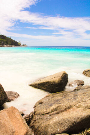 Big smooth rocky coast and turquoise sea on Seychellesの写真素材